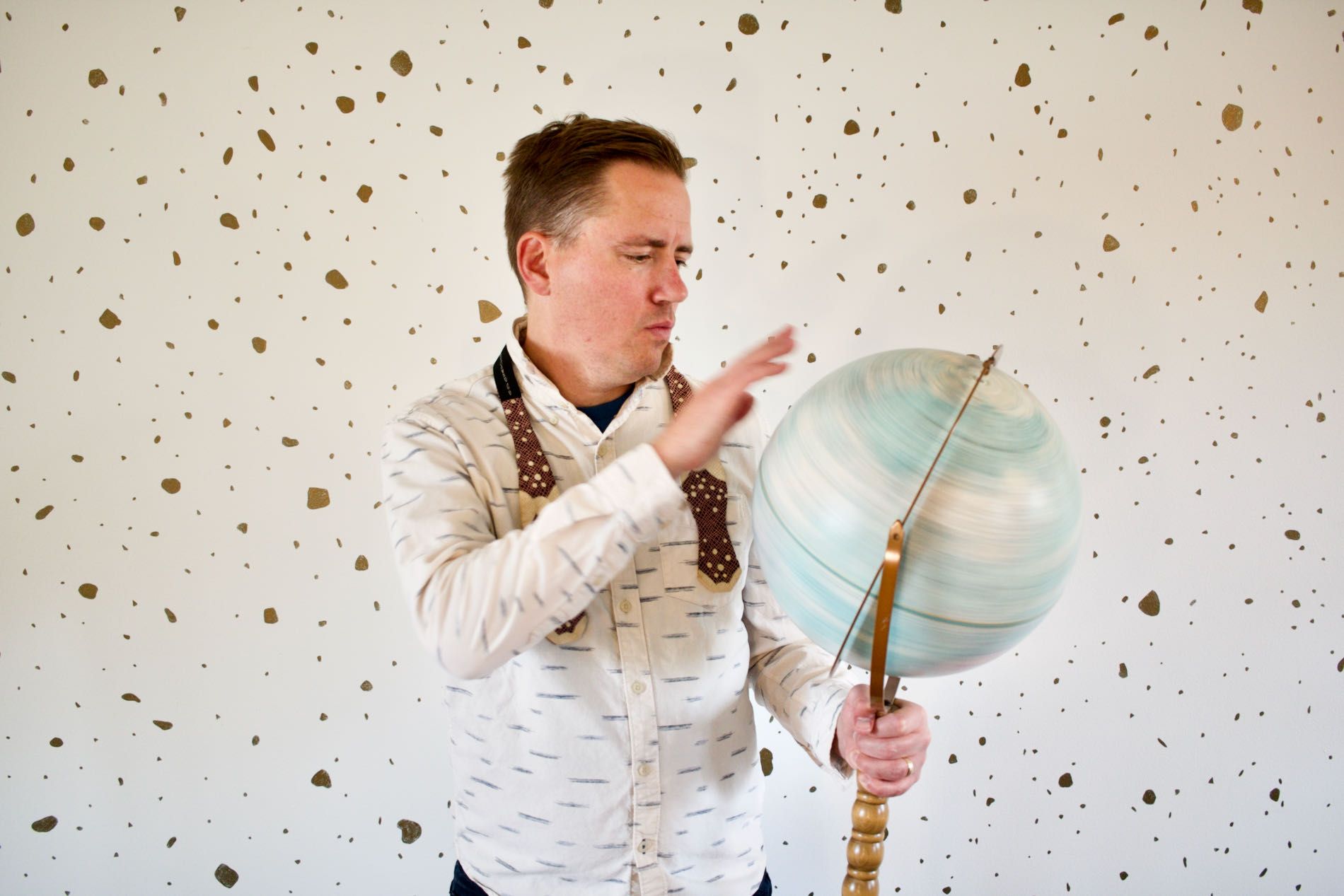 Musician Von Bieker spinning a globe